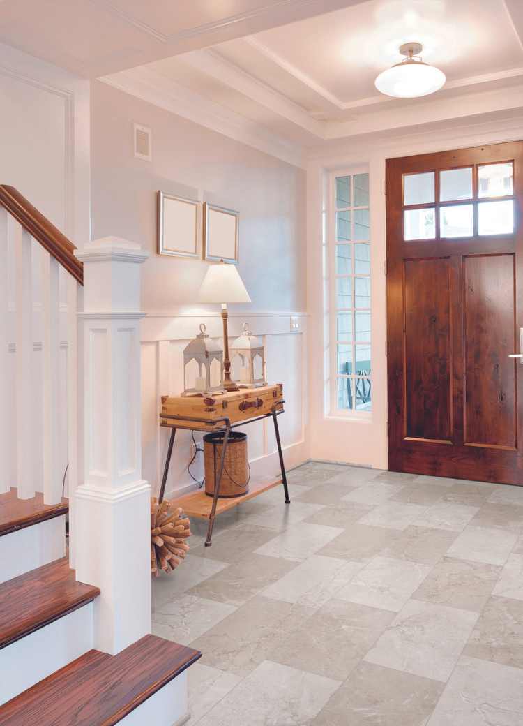 natural stone look luxury vinyl tile in modern entryway with wood accents